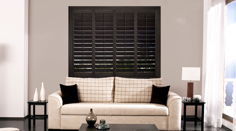 Charlotte sitting room with stained wood shutters.